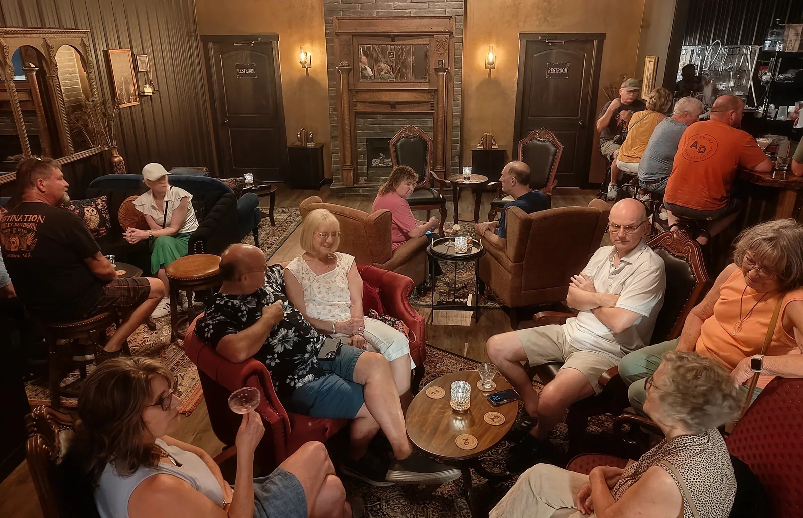 Guests gathered on velvet sofas and armchairs around the parlor fireplace