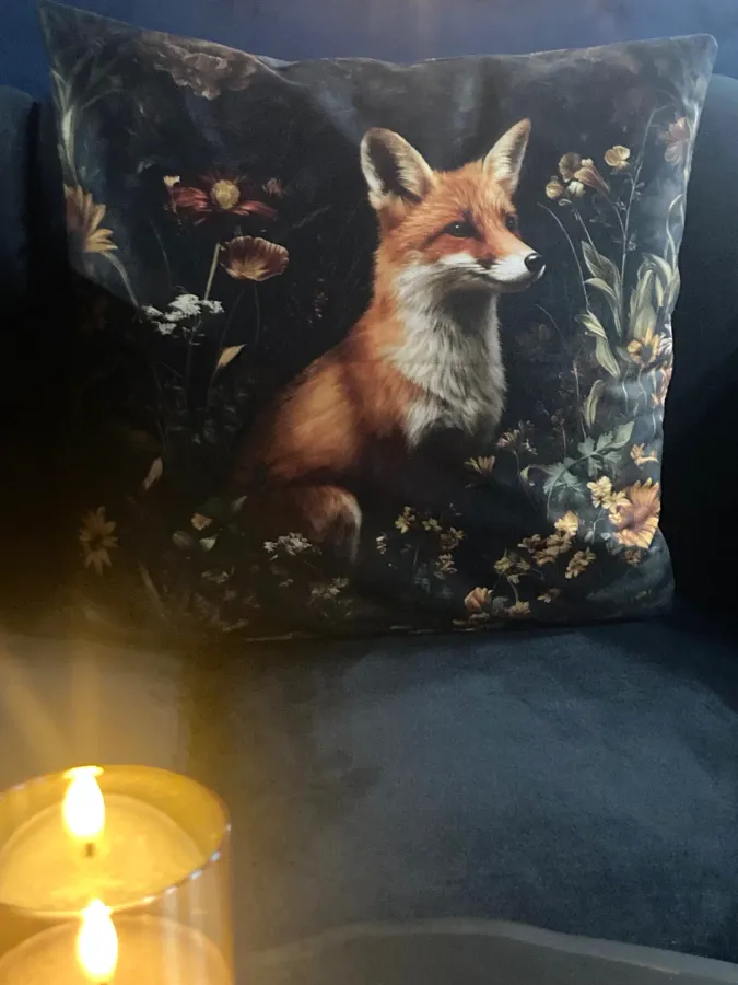 The fox pillow by candlelight on the velvet sofa