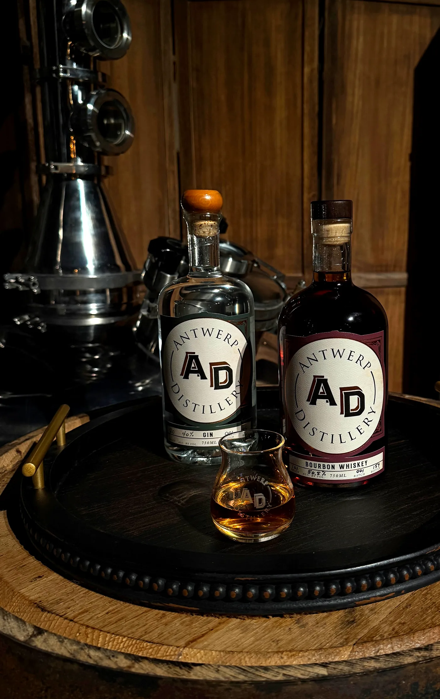 Antwerp Distillery rye and bourbon whiskey bottles on a barrel head